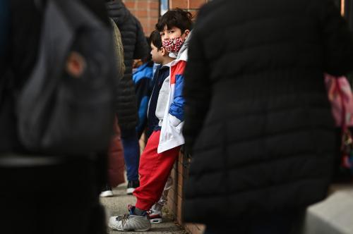 An accompanied student waits outside of his school after the masks policy for K through 12 was lifted, Queens, New York, NY, March 7, 2022.