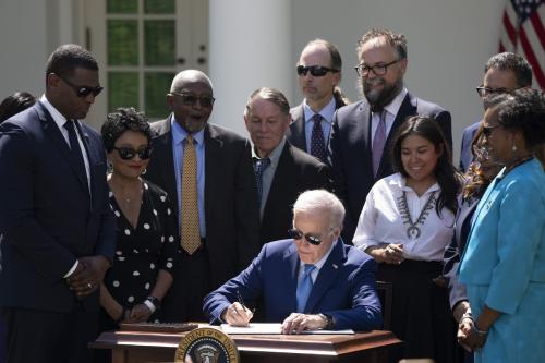 United States President Joe Biden signs an Executive Order on new actions to advance environmental justice in the Rose Garden of the White House on April 21, 2023.