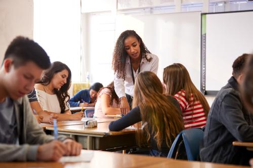 Women teacher with class full of children.