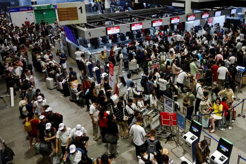 Air Asia passengers queue at counters inside Don Mueang International Airport Terminal 1 amid the global outage that disrupted the airline's operations, in Bangkok, Thailand, on July 19, 2024.