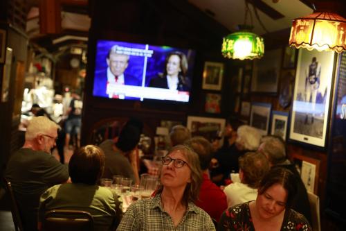 Audience members watch as Republican President Candidate Donald Trump and Democratic Candidate Kamala Harris debate on CNN on September 10, 2024 in Bloomington, Indiana. After earning the Democratic Party nomination following President Joe Biden's decision to leave the race, Democratic presidential nominee, U.S. Vice President Kamala Harris faces off with Republican presidential nominee former President Donald Trump.