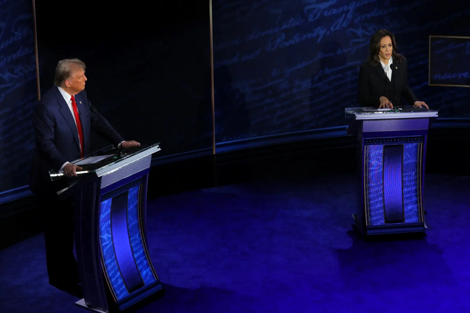 Democratic presidential nominee, U.S. Vice President Kamala Harris speaks during a presidential debate hosted by ABC as Republican presidential nominee, former U.S. President Donald Trump listens, in Philadelphia, Pennsylvania, U.S., September 10, 2024.