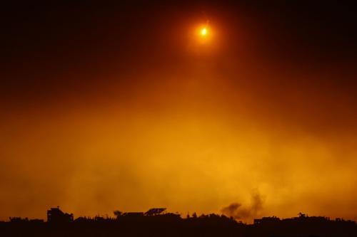 A flare falls over Gaza, amid the ongoing conflict between Israel and the Palestinian Islamist group Hamas, as seen from southern Israel, December 7, 2023.