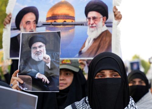 A woman holds a picture of Lebanon's Hezbollah Chief Hassan Nasrallah who was killed by an Israeli airstrike in Beirut, during a symbolic funeral in Basra, Iraq, September 29, 2024. REUTERS/Essam al-Sudani