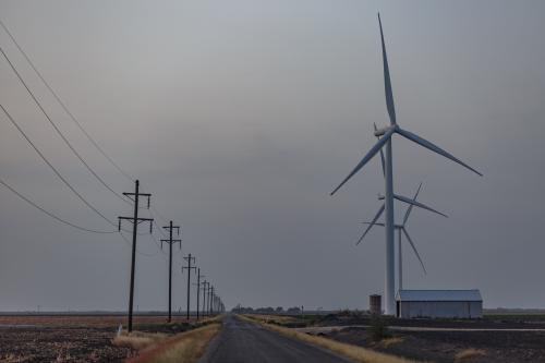 Electric power lines and windmills line a rural road in Taft, Texas during a heat wave on July 17, 2022. (Photo by Bryan Olin Dozier/NurPhoto)