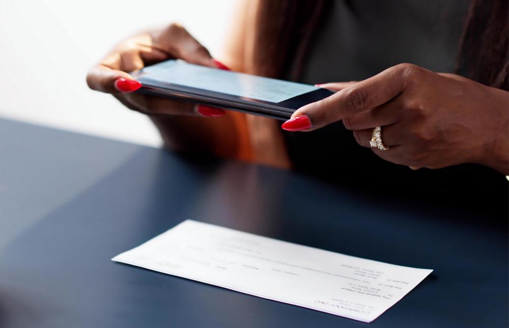 Person mobile depositing paper check